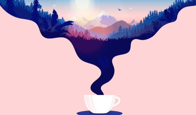Coffee cup with steam and a beautiful sunrise in a landscape with forest, mountains and blue sky.