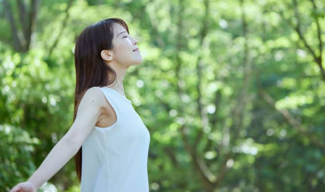 Japanese woman forest bathing.