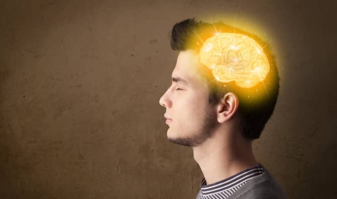Man in profile with a glowing yellow brain illustration superimposed on his head against a textured brown background.
