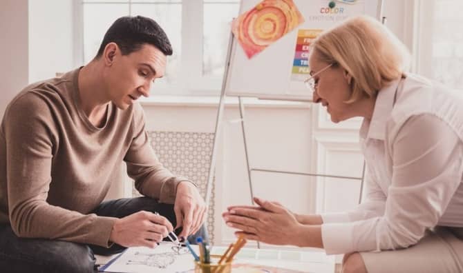 A young man in an art therapy session.