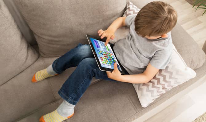 kid using an app on a tablet.