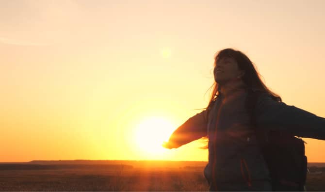 A happy girl closes her eyes.