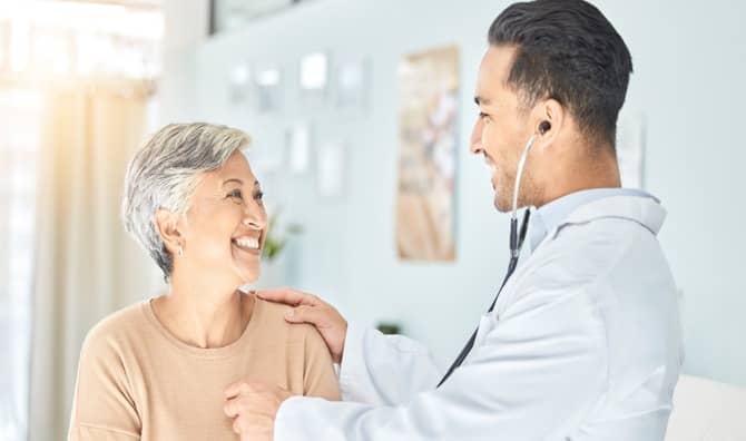 Cardiologist listening to a senior patient’s heart.
