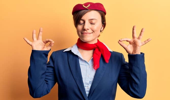 A flight attendant leading plane yoga.
