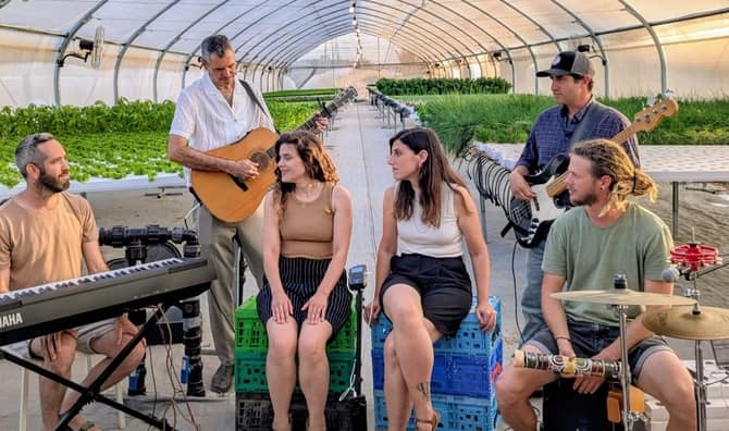 Hashayara plays music in a greenhouse.