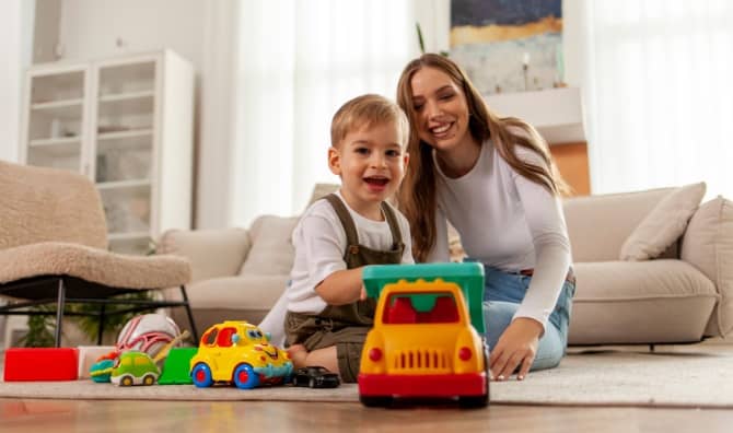 A kid plays with a toy car.