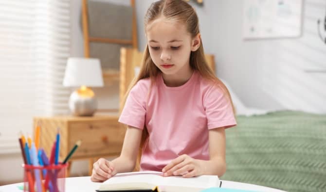 Dyslexic girl using a tool to help her read.