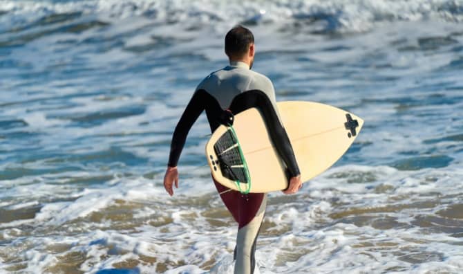 Surfer wearing a wetsuit.