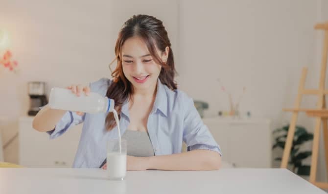 Enjoying a glass of non-dairy milk.