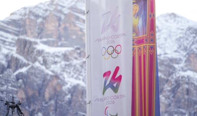 Coerina D'Ampezzo, Italy with the Olympic flag.