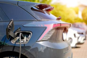 Electric vehicle charging in a residential neighborhood.