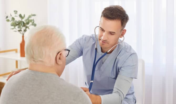 Young doctor examining an elderly patient.
