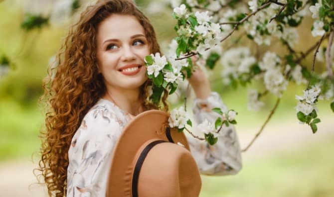 A woman in a blooming garden.