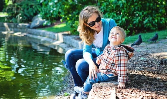 A mother and son playing in a park.