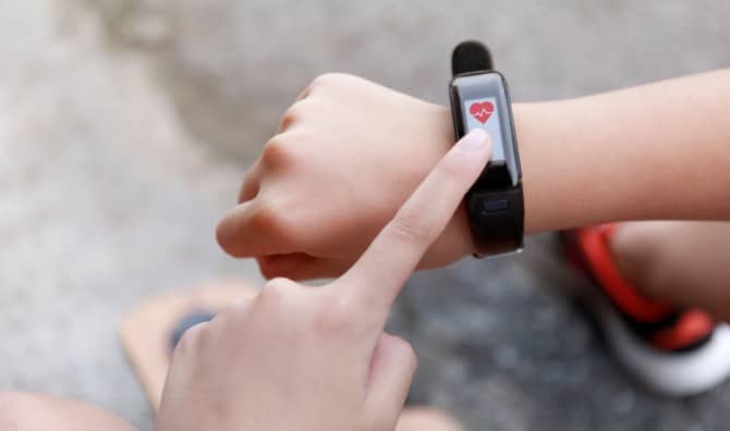 A girl touches a smartwatch.