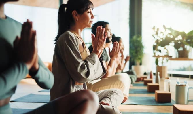 People relaxing in a yoga class.