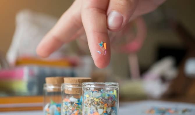 A shot of microplastics on a child's fingers.