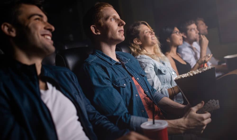 A group of people watching a movie in a theater.