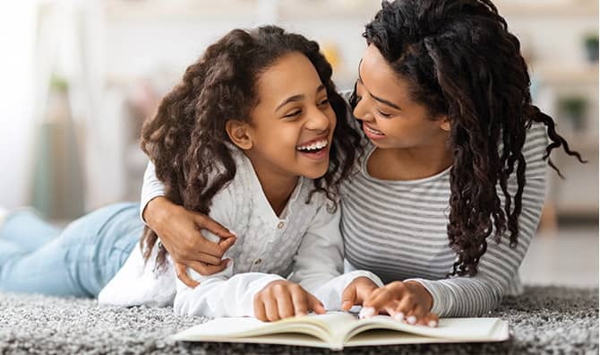 Mother and daughter reading about Black history.