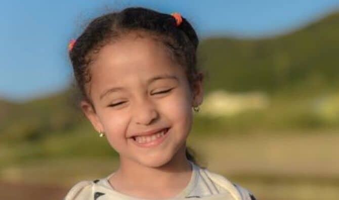 An Arab girl smiles sweetly.