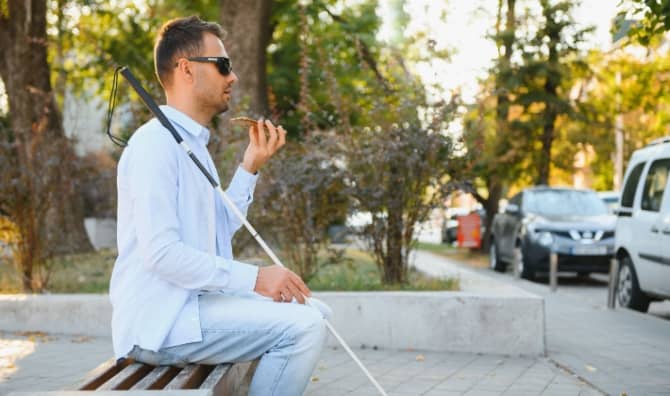 A partially-sighted man navigates public transport with the aid of technology.
