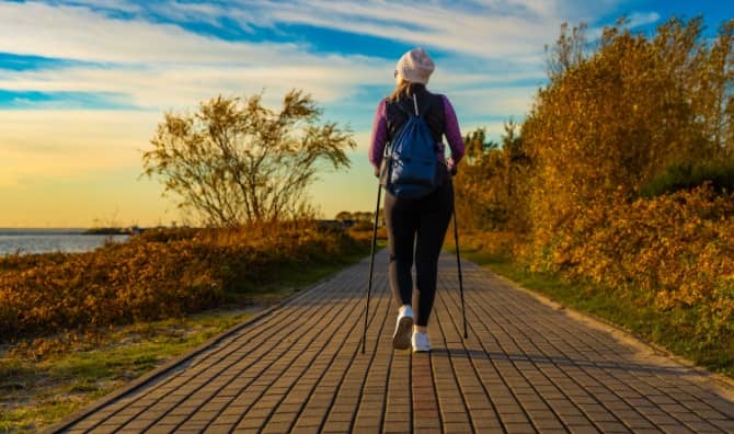 A woman practicing Nordic walking.