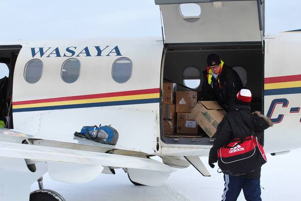 Emma's brother Jack delivers boxes of new tablets, skates and hockey equipment to an aboriginal reserve at Cat Lake