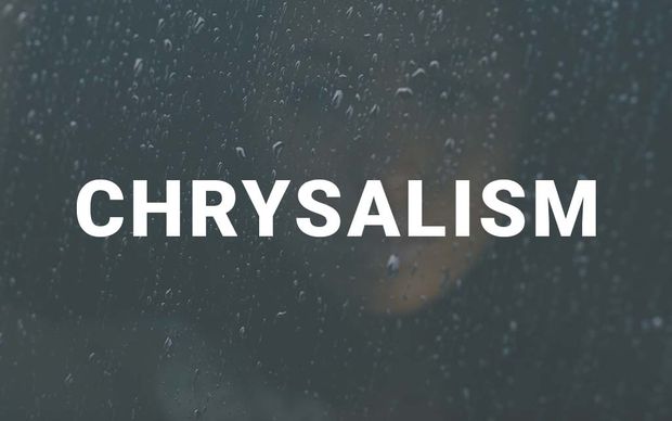 Raindrops on a dark window pane with a soft, blurred warm light glowing in the background, with the word 'CHRYSALISM' displayed in large white capital letters across the center of the image.