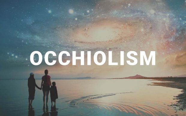Silhouettes of a family — two adults and a child — holding hands on a beach shoreline, gazing up at a surreal sky filled with swirling galaxies and cosmic clouds, with the word 'OCCHIOLISM' displayed in large white capital letters across the center of the image.