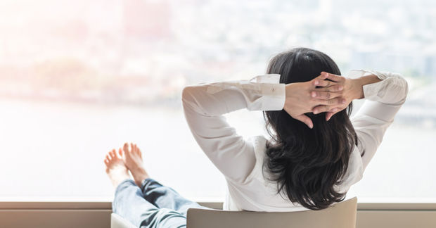 woman sitting on a chair legs infront watching the sky