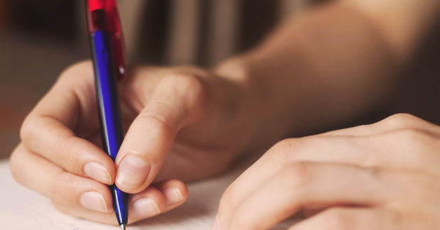 hand holding a pen writing