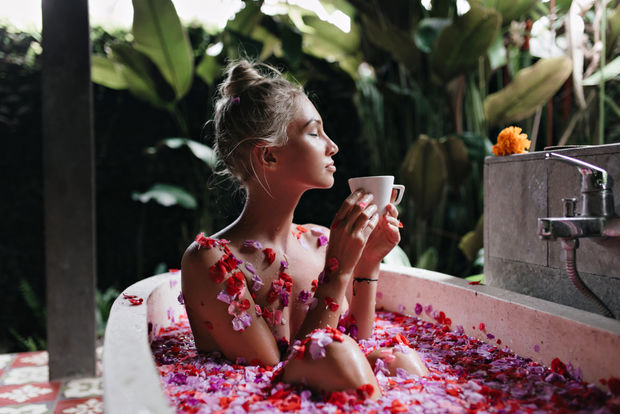 Woman taking a bath with tea leaves