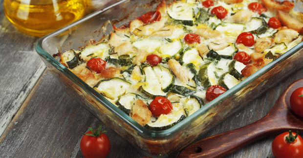 Baked vegetable casserole with zucchini and cherry tomatoes.
