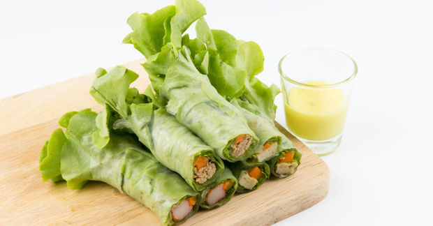 Fresh lettuce wraps with vegetables and green juice.