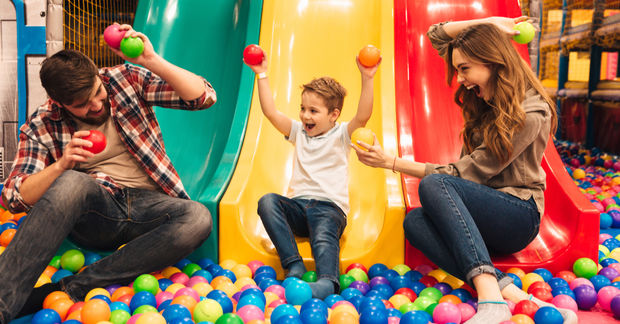Parents playing with their child.