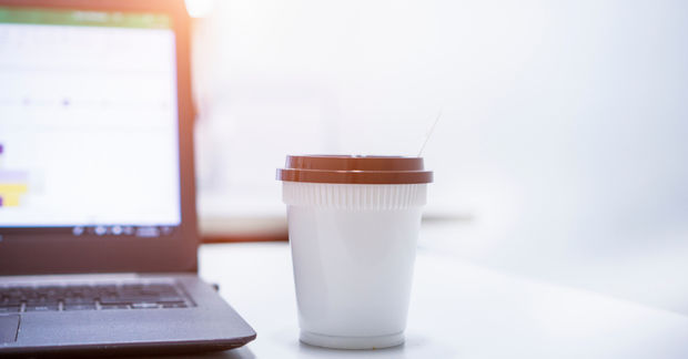 Hot Hot espresso on the desk by a laptop computer to help with focus.