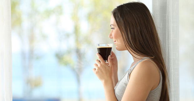 A A pensive woman drinking coffee.