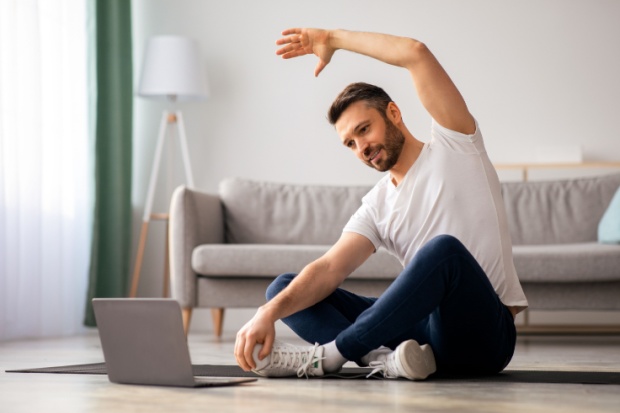 A man stretching at home.
