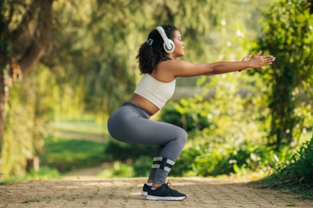 A woman performing a squat.